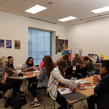 an art classroom full of students working on projects