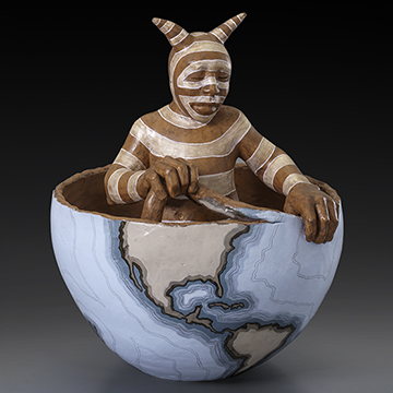 a striped figure sitting inside a half-built globe that he is creating with clay coils