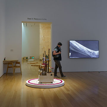 a person walks through the Actions for the Earth Exhibition at the Nerman Museum