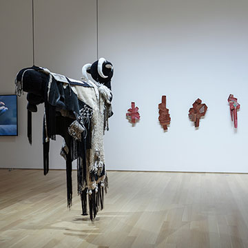 a work of art hangs from the gallery ceiling at the Actions for the Earth Exhibition at the Nerman Museum